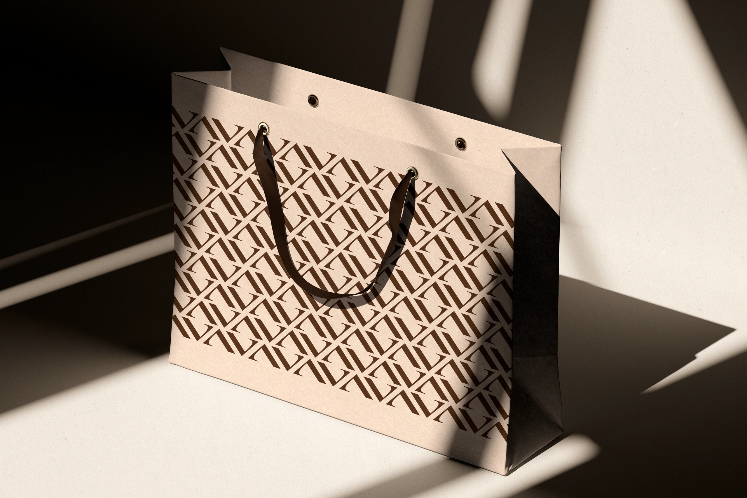 Edle Papiertragetasche mit Monogramm-Muster als Beispiel für Verpackungsdesign und Markenidentität